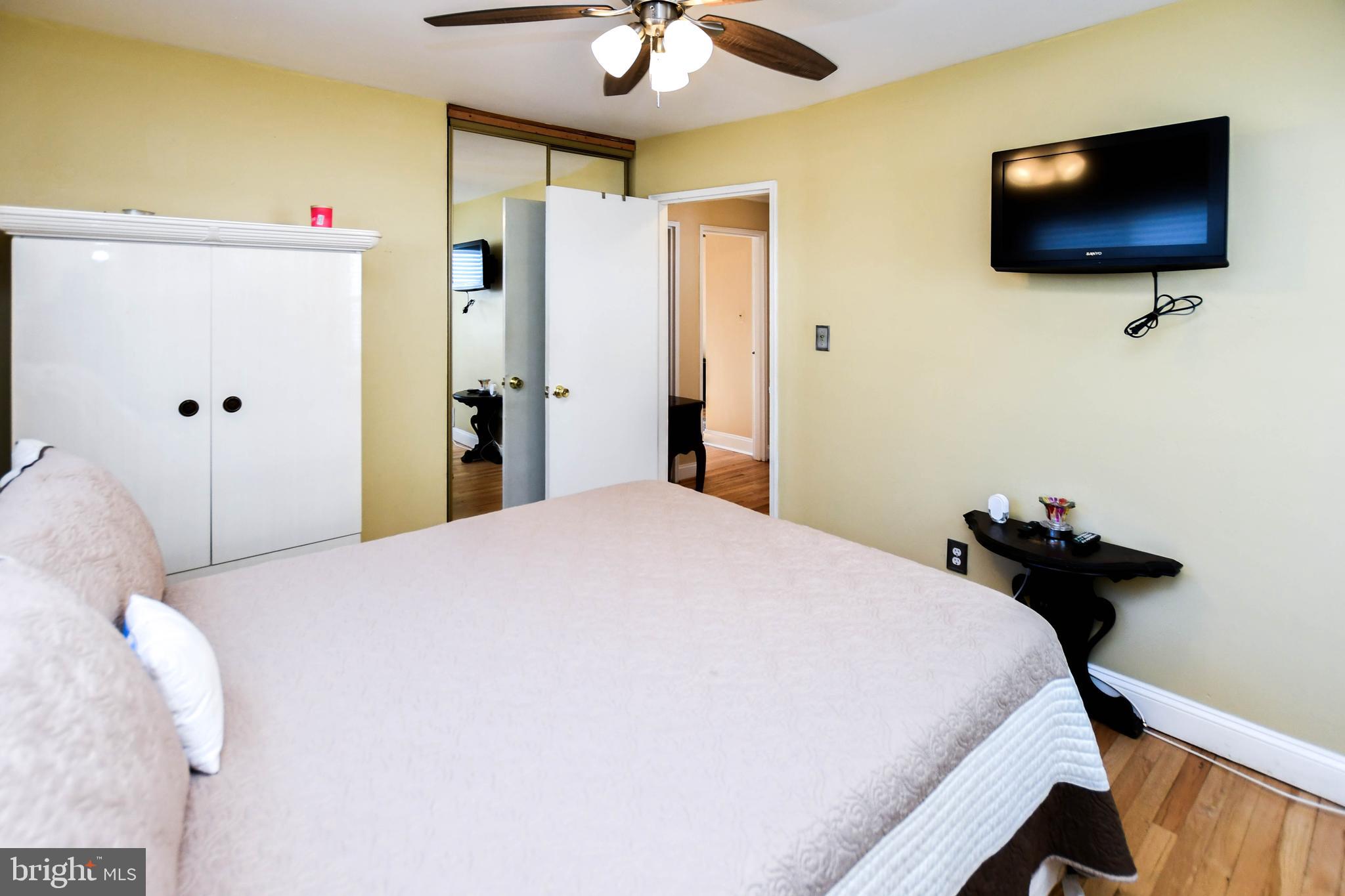 6714 Darby Road Hyattsville, MD 20784 - Photo 18 of 35 a bedroom with a bed and a flat screen tv