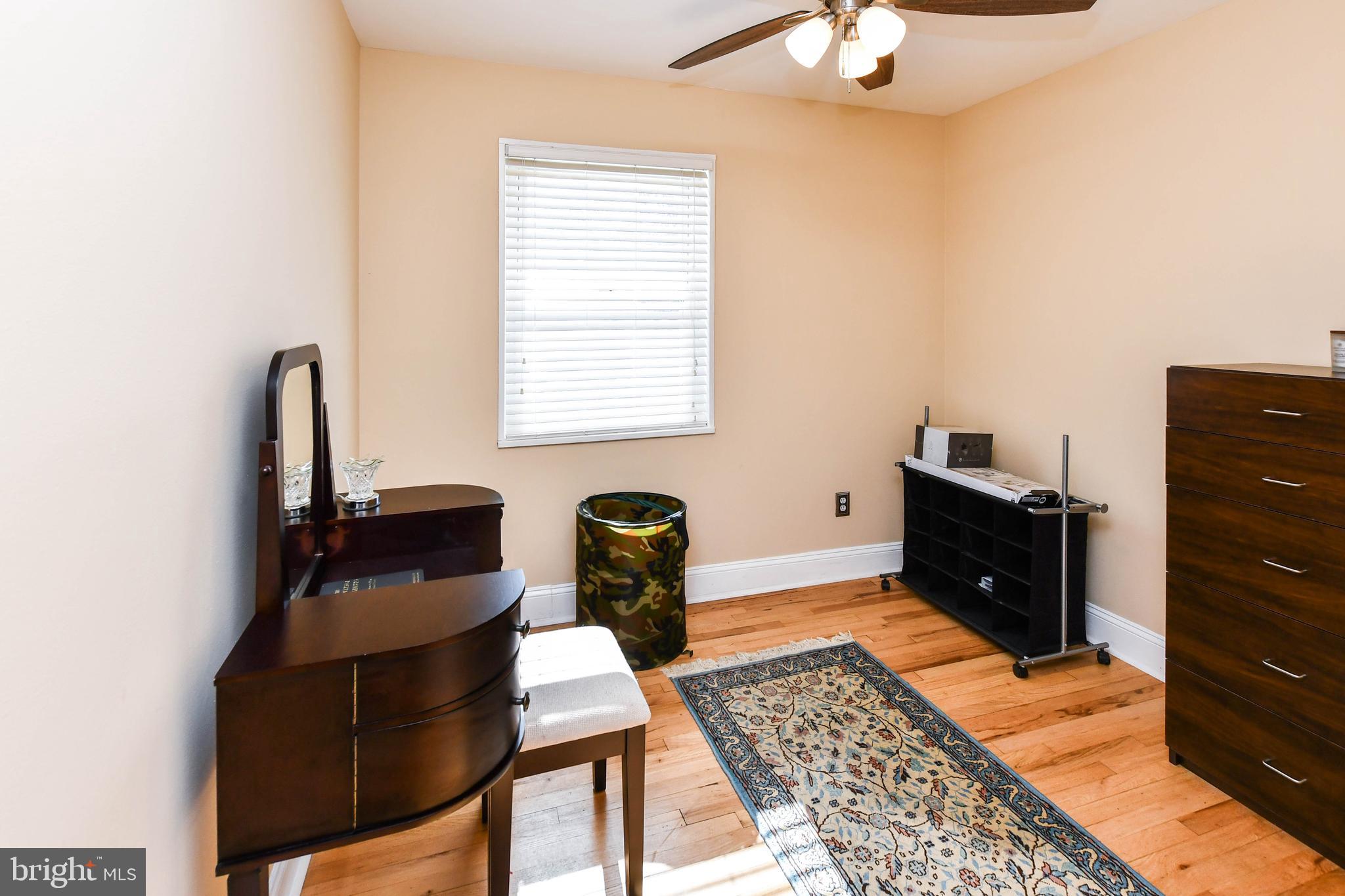 6714 Darby Road Hyattsville, MD 20784 - Photo 20 of 35 a bed room with a bed and a dresser