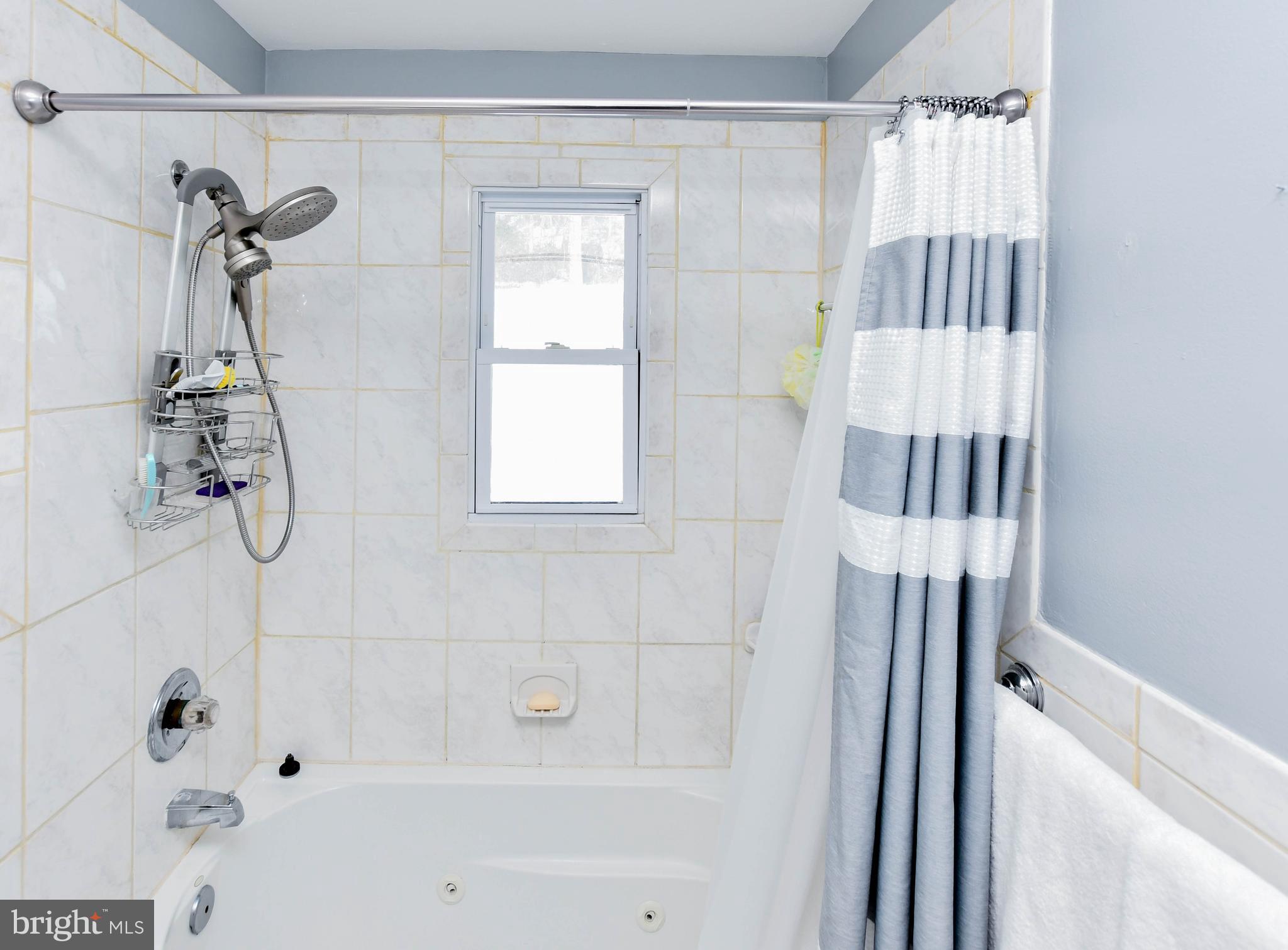 6714 Darby Road Hyattsville, MD 20784 - Photo 21 of 35 a bathroom with a bathtub and shower