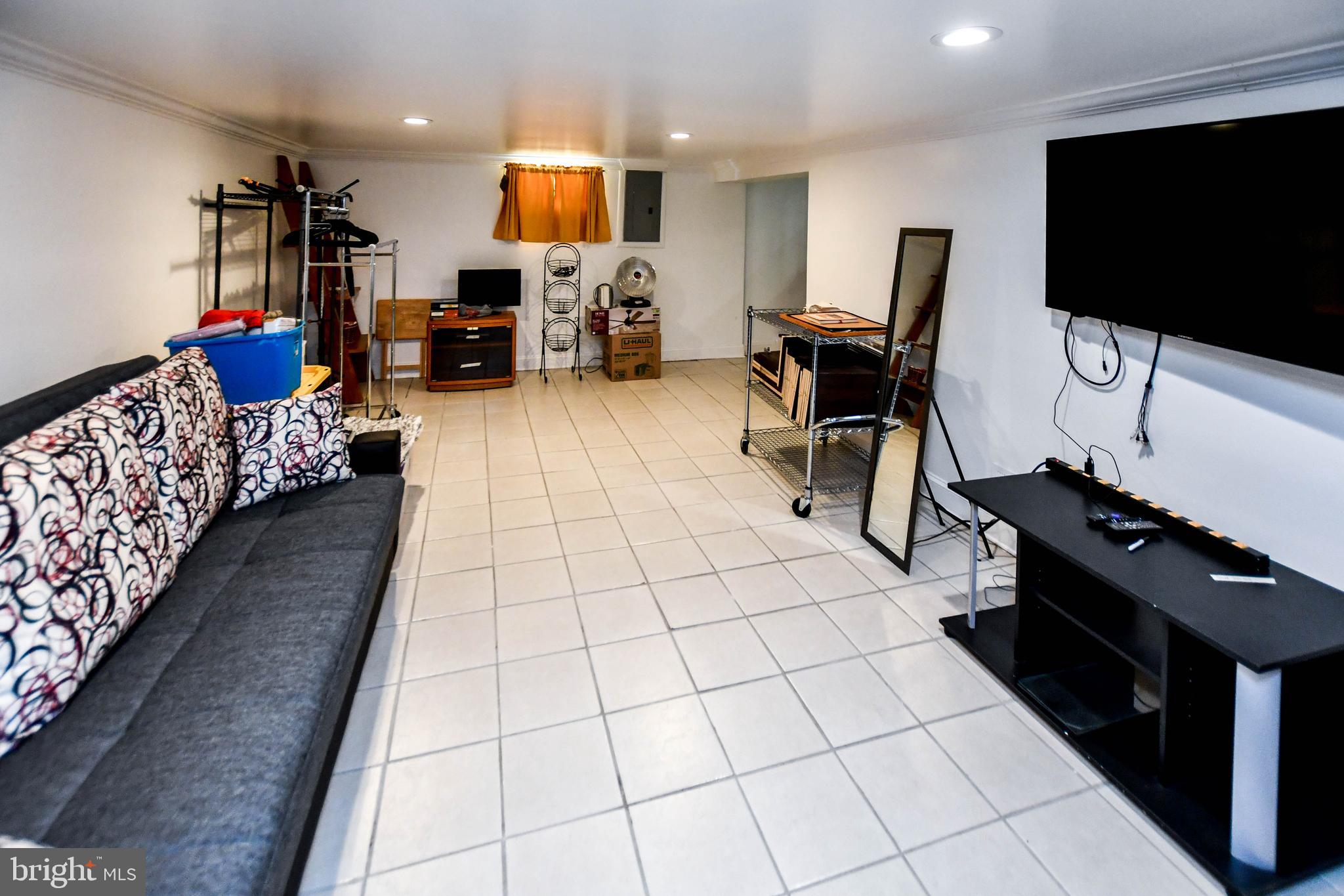 6714 Darby Road Hyattsville, MD 20784 - Photo 24 of 35 a living room with furniture and a flat screen tv