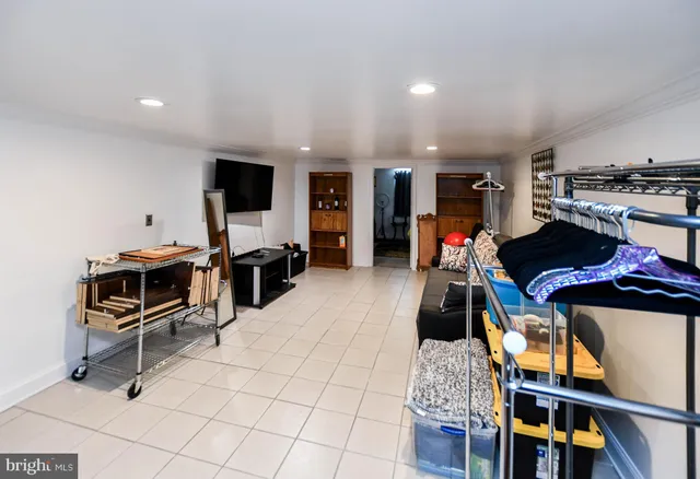 a room with gym equipment and a flat screen tv