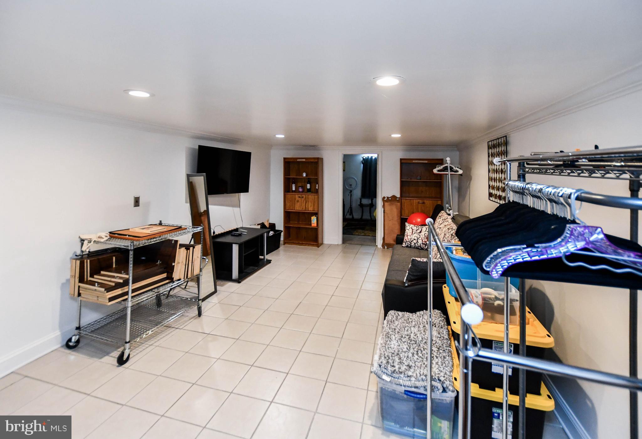 6714 Darby Road Hyattsville, MD 20784 - Photo 25 of 35 a living room with furniture a flat screen tv and a refrigerator