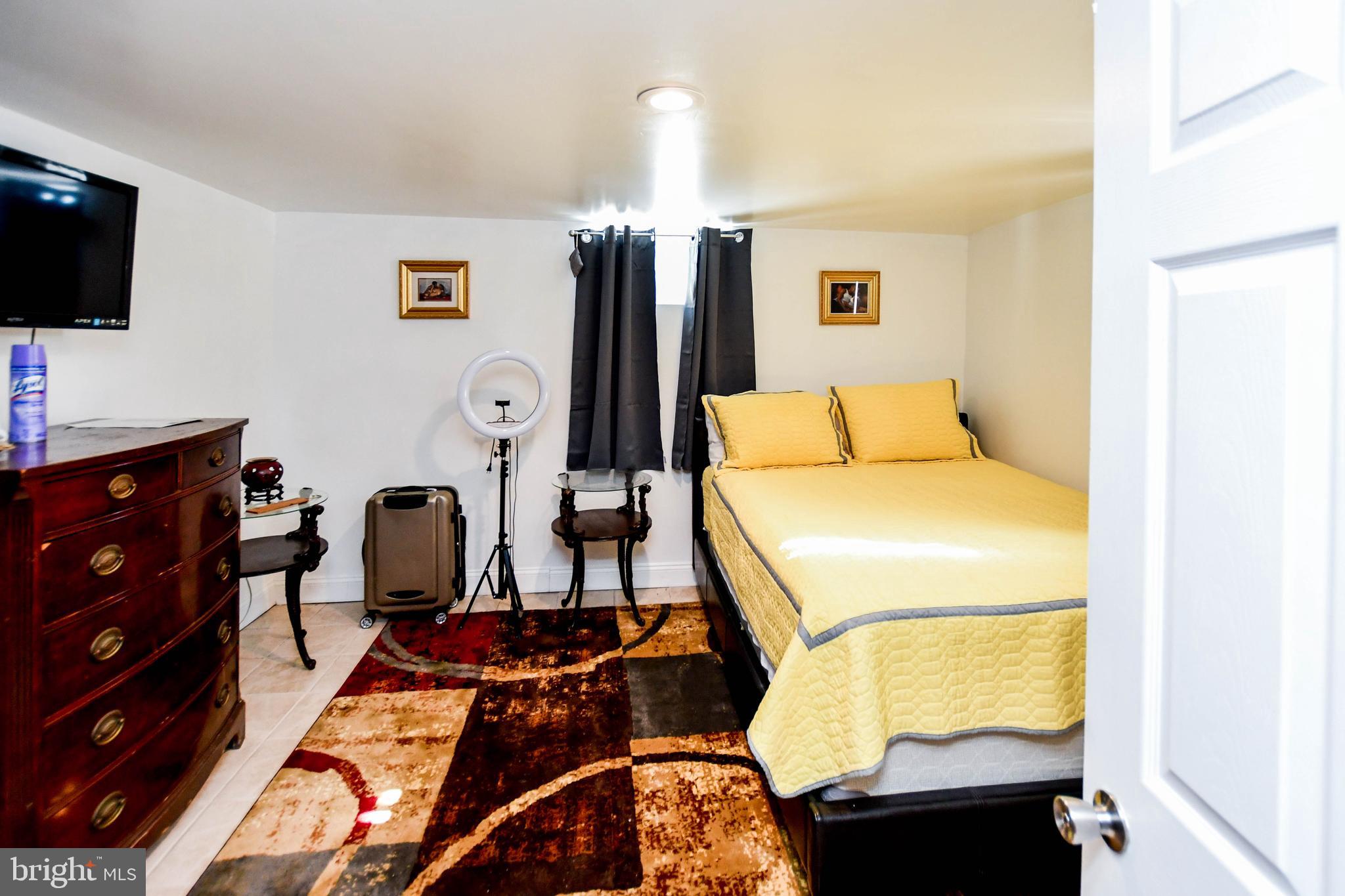6714 Darby Road Hyattsville, MD 20784 - Photo 26 of 35 a room with gym equipment and a flat screen tv