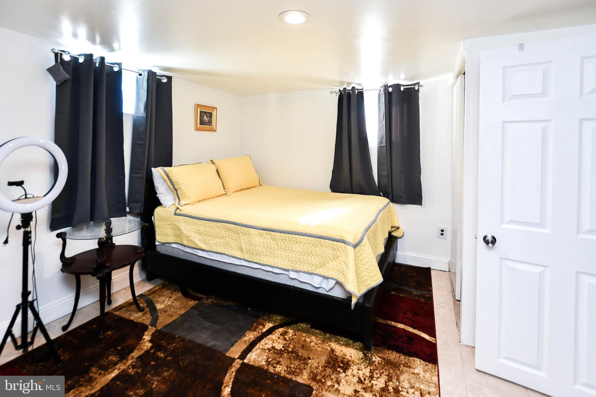 6714 Darby Road Hyattsville, MD 20784 - Photo 27 of 35 a bedroom with a bed a dresser and a potted plant