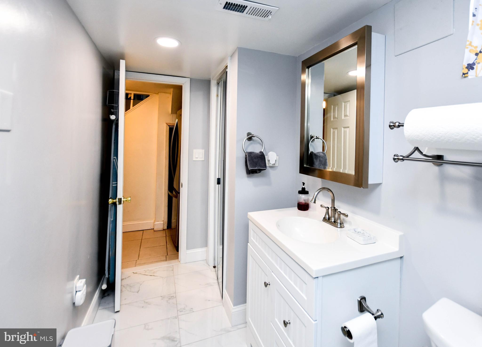 6714 Darby Road Hyattsville, MD 20784 - Photo 31 of 35 a bathroom with a sink and a mirror