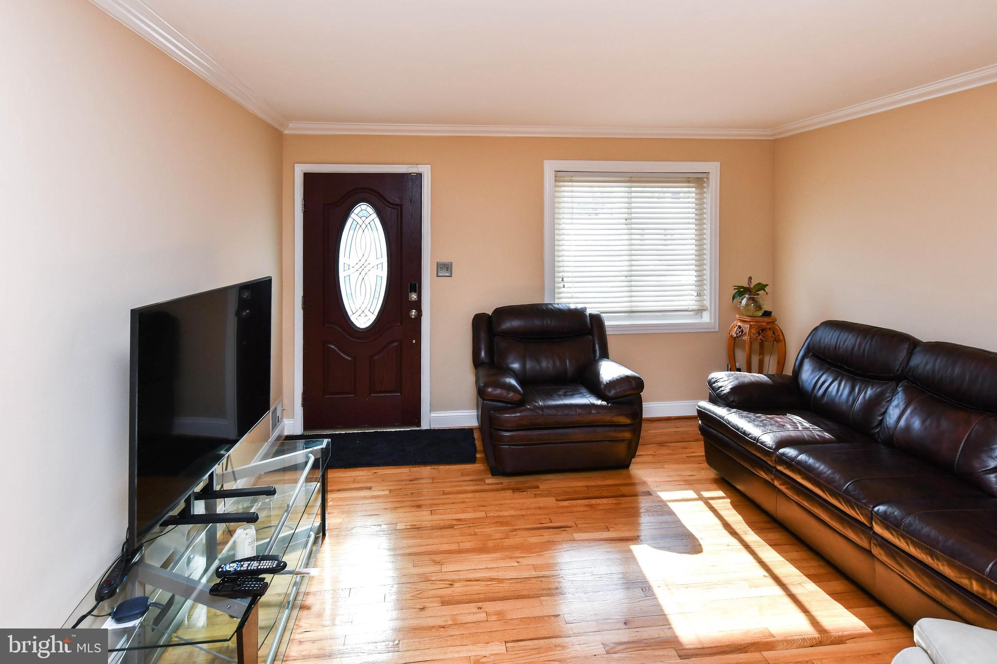 6714 Darby Road Hyattsville, MD 20784 - Photo 5 of 35 a living room with furniture a flat screen tv and a window