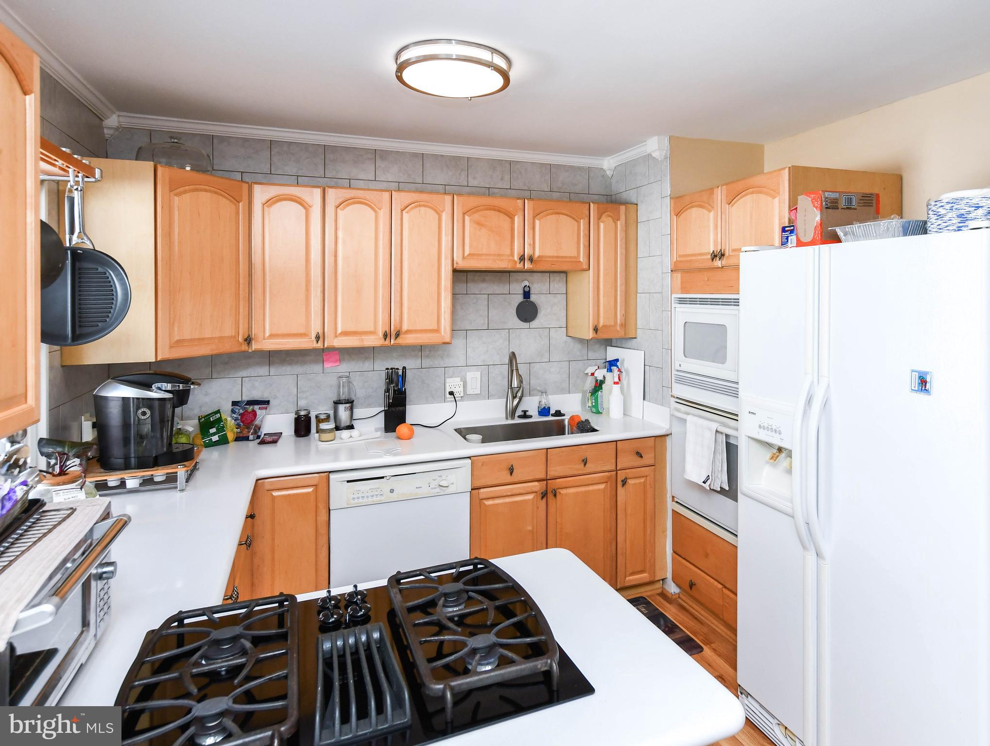 6714 Darby Road Hyattsville, MD 20784 - Photo 9 of 35 a kitchen with stainless steel appliances granite countertop a stove a sink and a refrigerator