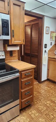 a view of an empty room with wooden floor and a cabinet