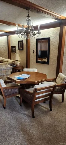 a living room with furniture pool table and flat screen tv