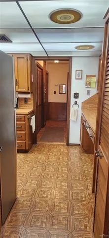 a view of a kitchen with refrigerator and window