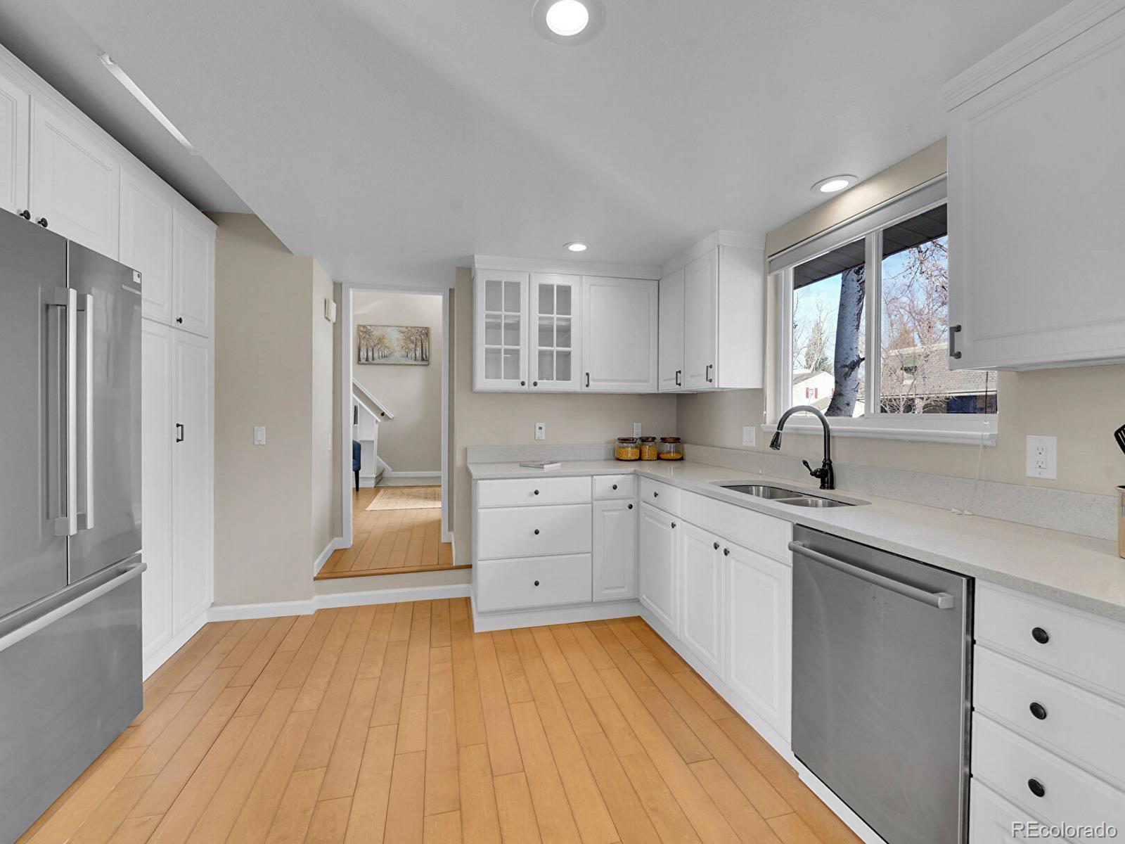 6849 South Elizabeth Circle Centennial, CO 80122 - Photo 13 of 44 a large kitchen with cabinets wooden floor and stainless steel appliances