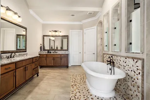 a bathroom with a bathtub sink and mirror