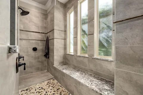 a bathroom with a glass door shower