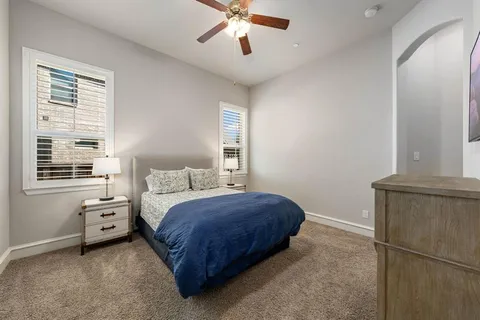 a spacious bedroom with a bed and a window