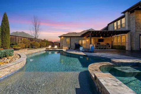 a swimming pool with outdoor seating and yard