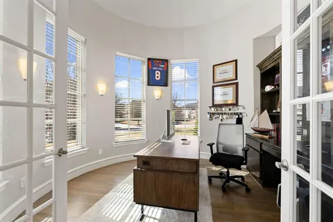 a view of a livingroom with workspace and a window