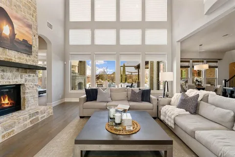 a living room with furniture large window and a fireplace