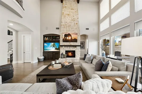 a living room with furniture fireplace and a large window