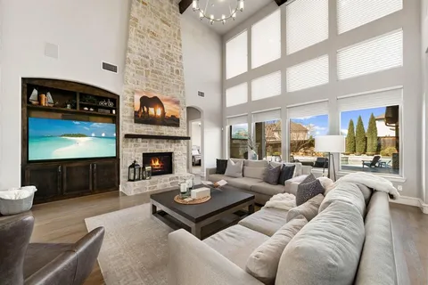 a living room with furniture a fireplace and a flat screen tv