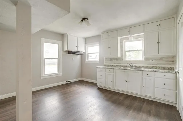 a view of a kitchen and wooden floor
