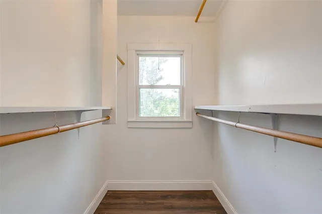 a view of a room with rack on the wall and a window