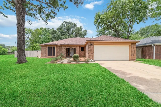 a front view of a house with yard patio and green space