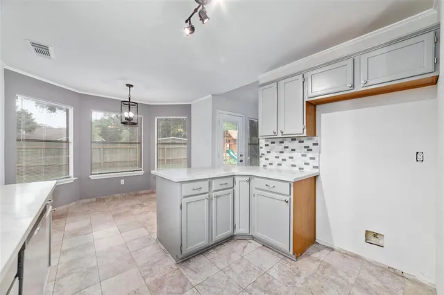 a kitchen with granite countertop a sink stove and cabinets
