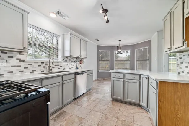 a kitchen with granite countertop white cabinets and appliances