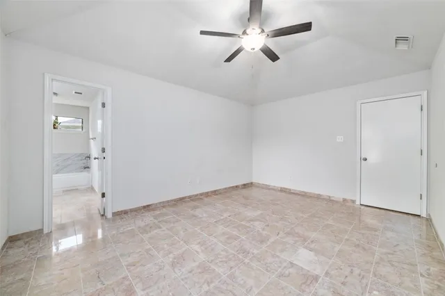a bathroom with a granite countertop sink a toilet and bathtub