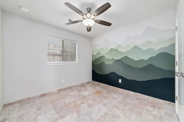 a view of a house with a yard potted plants and large tree