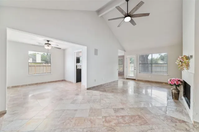 a view of a livingroom with a ceiling fan and entryway