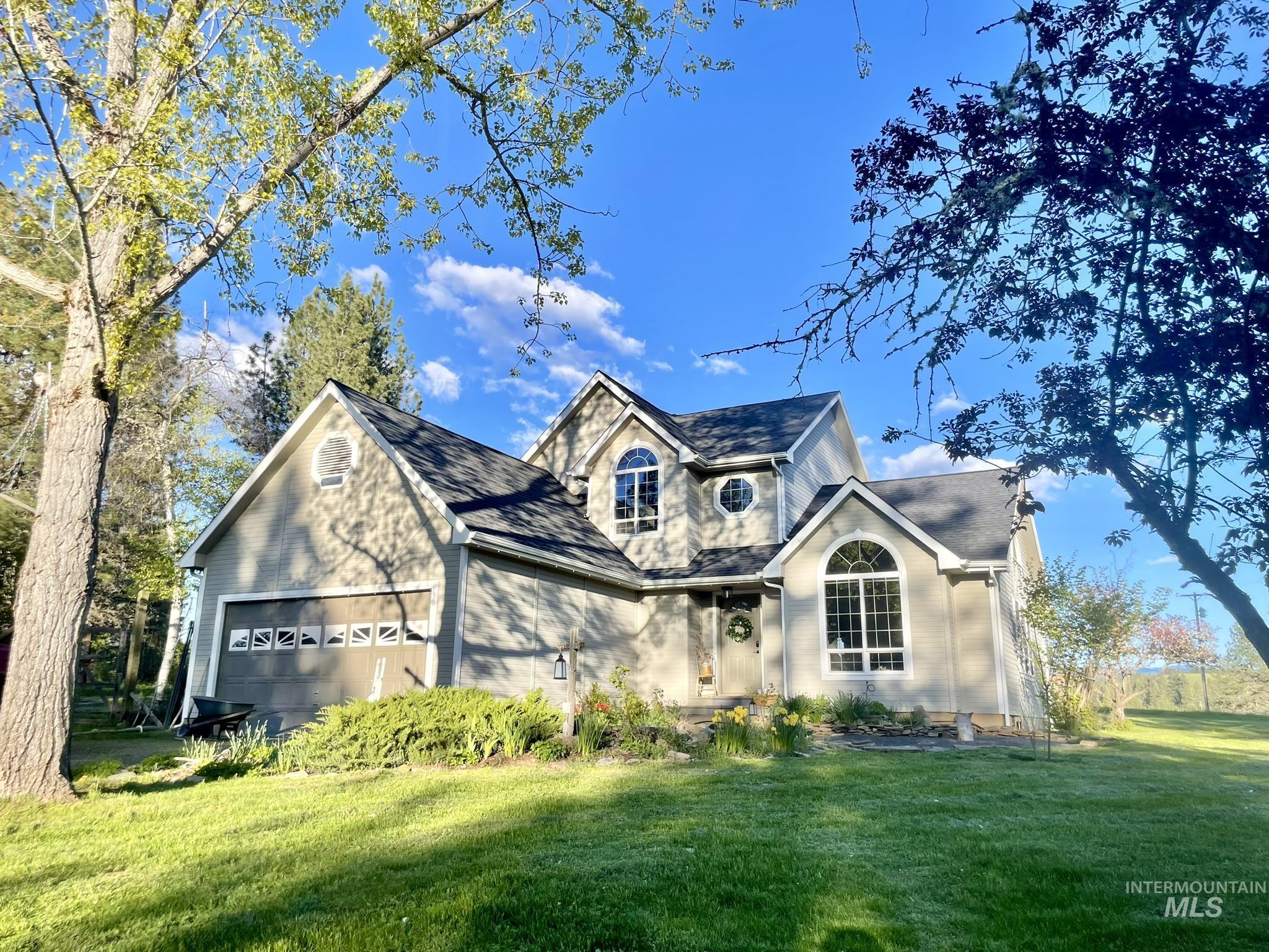 Traditional-style home with a front yard and an attached garage