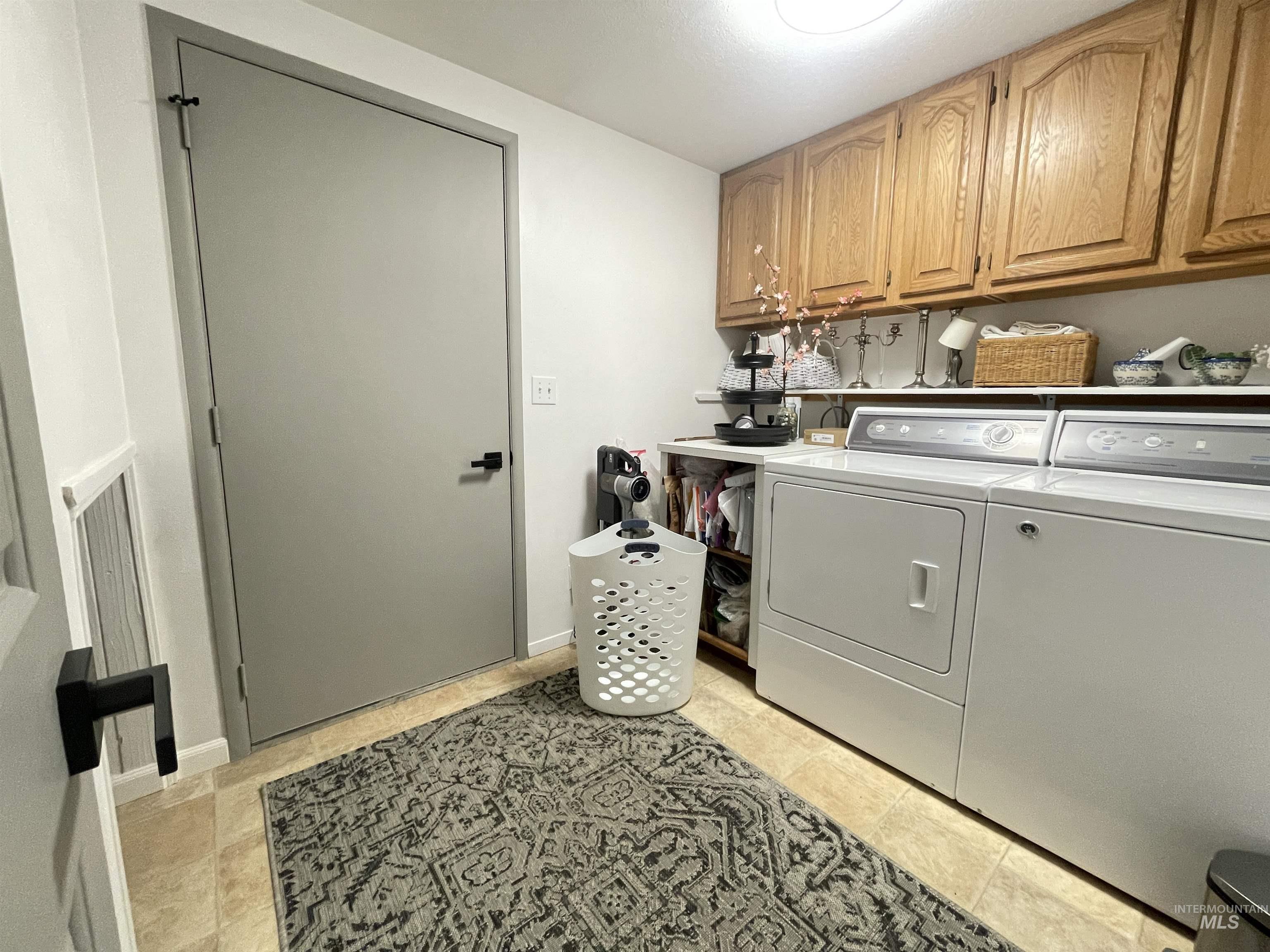 637 Leitch Creek Road Kooskia, ID 83539 - Photo 16 of 38 Laundry room featuring cabinet space and separate washer and dryer