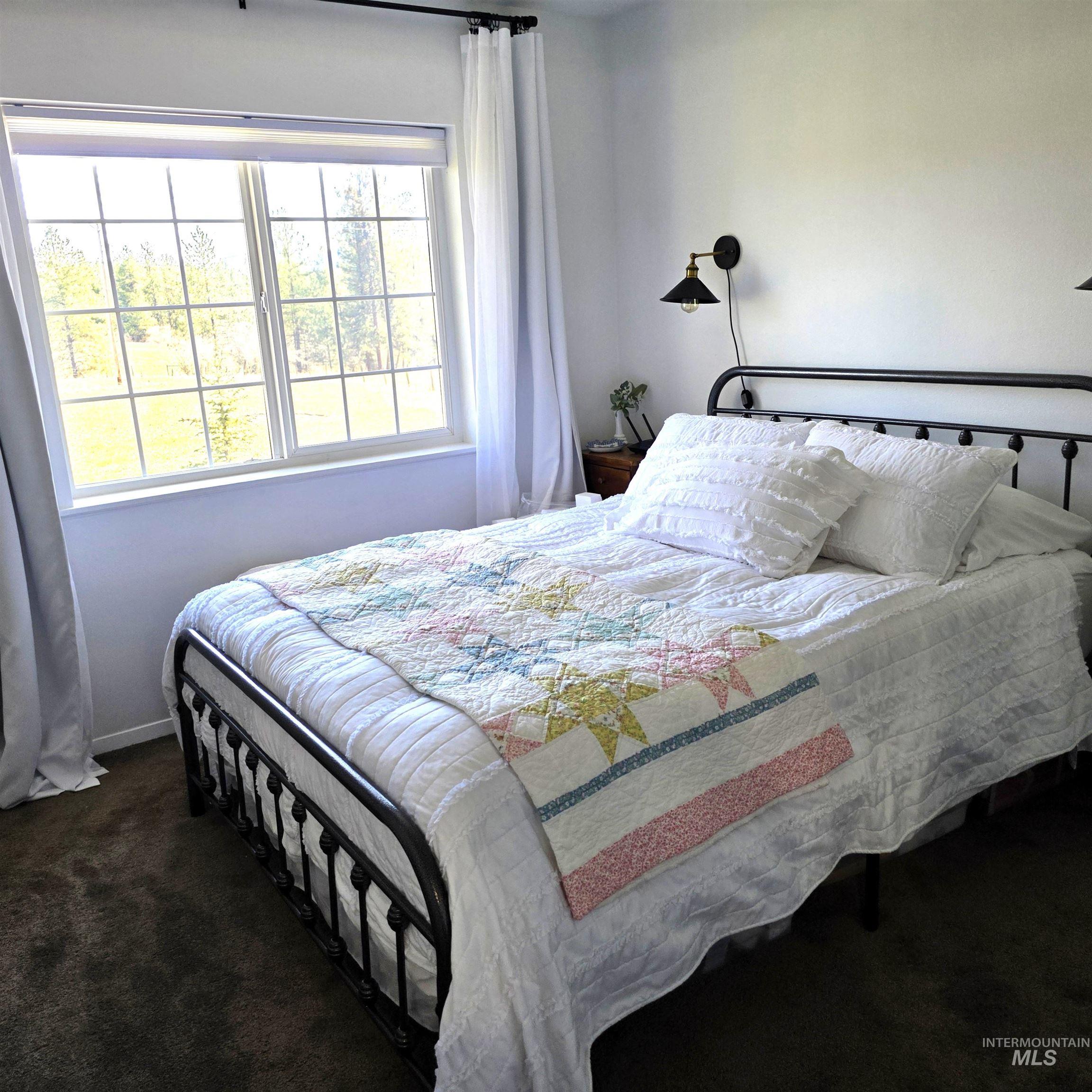 637 Leitch Creek Road Kooskia, ID 83539 - Photo 22 of 38 Bedroom with dark carpet and baseboards