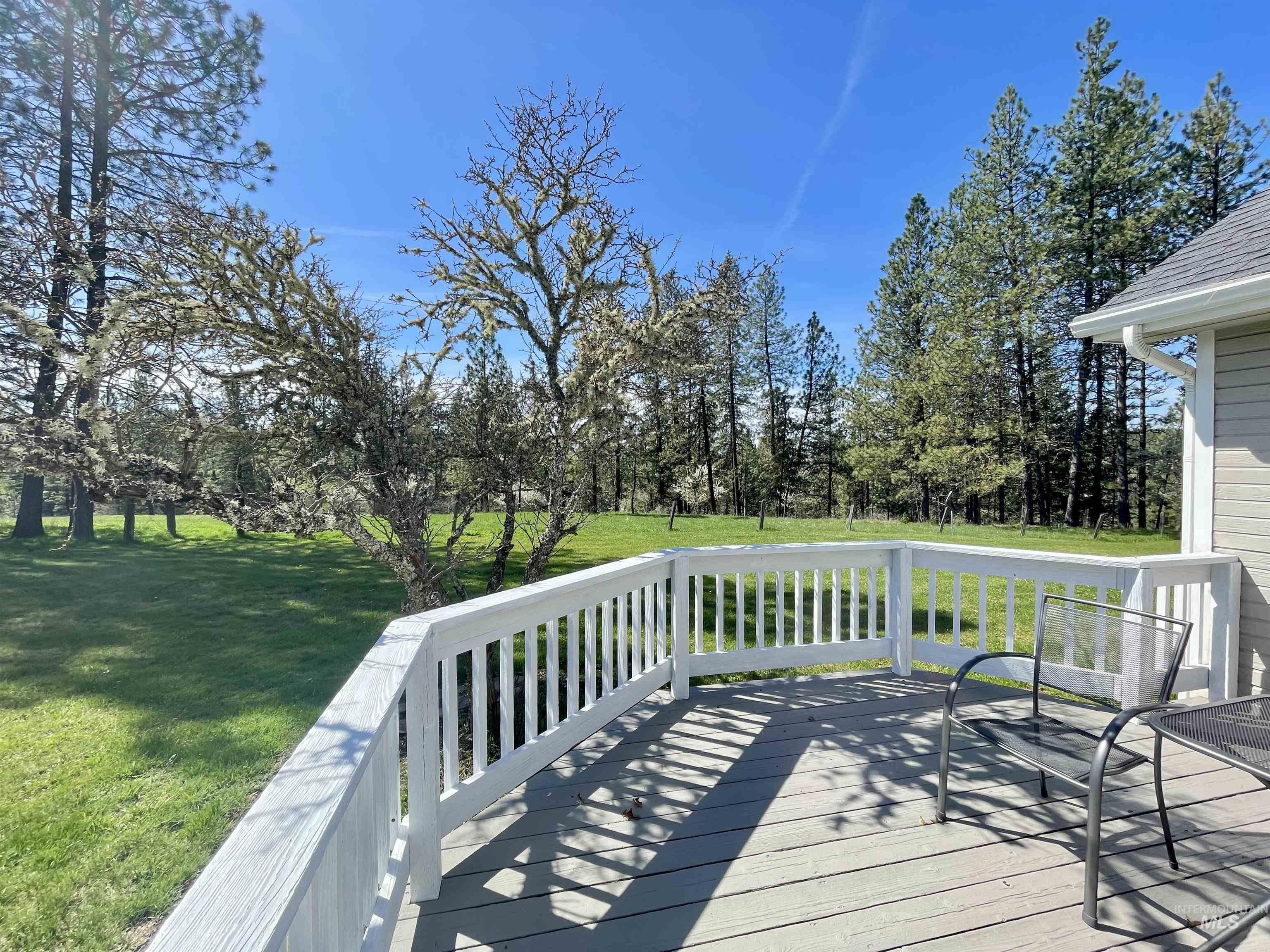 637 Leitch Creek Road Kooskia, ID 83539 - Photo 25 of 38 Deck with a lawn and view of scattered trees