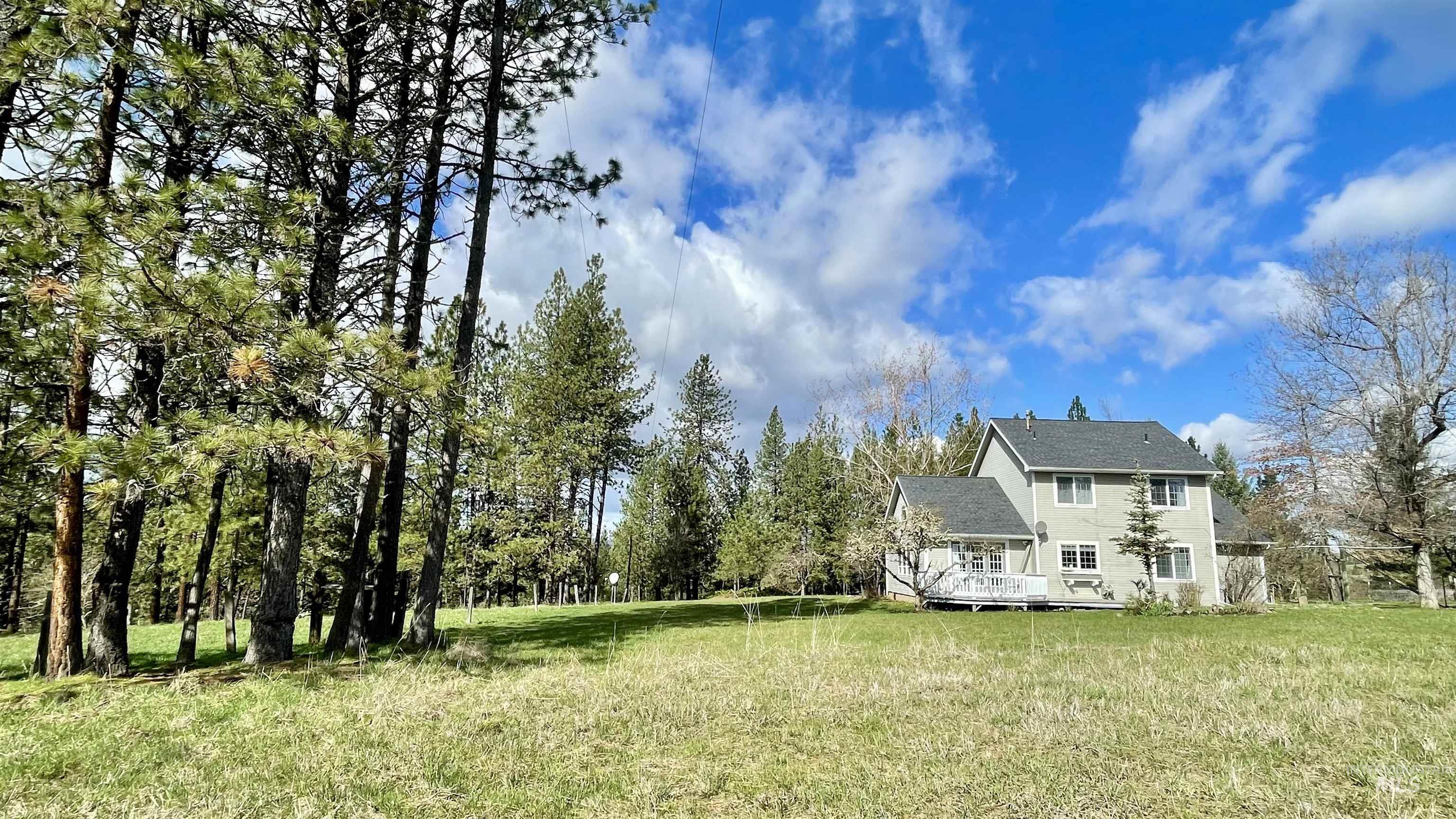 637 Leitch Creek Road Kooskia, ID 83539 - Photo 5 of 38 Rear view of property featuring a deck, a lawn, and roof with shingles