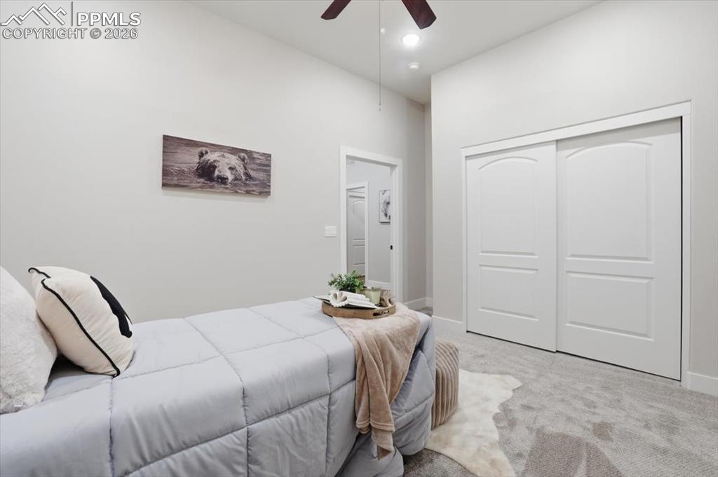 15755 Fool's Gold Lane Colorado Springs, CO 80921 - Photo 25 of 50 a bedroom with a bed and a chandelier