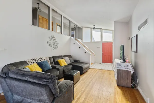 a living room with furniture and wooden floor