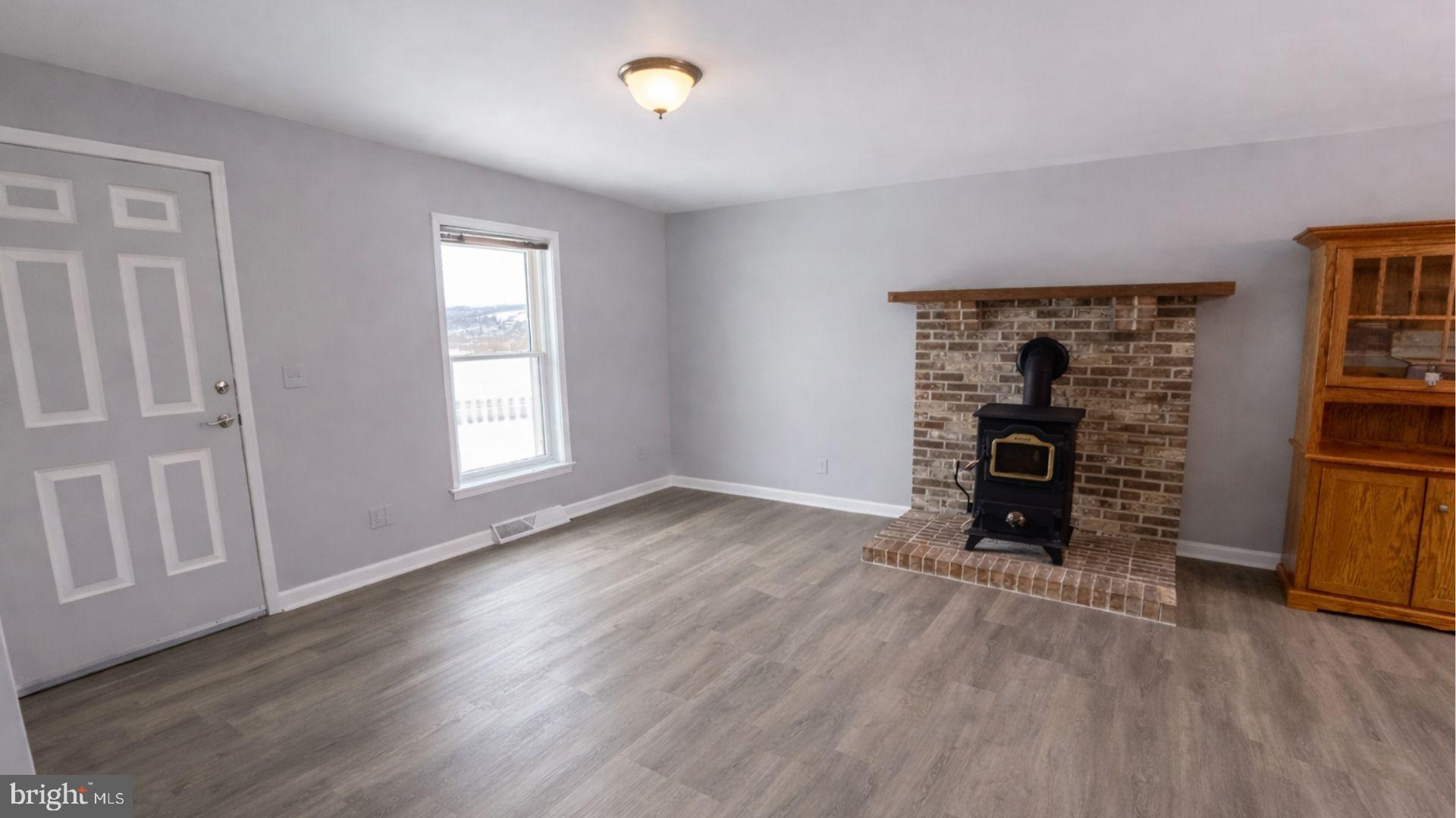 2134 Cemetery Road Seven Valleys, PA 17360 - Photo 2 of 10 wooden floor in an empty room with a window