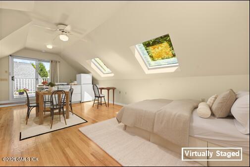 a spacious bedroom with a bed a table and chairs