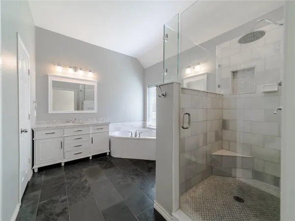 a bathroom with a shower sink and mirror