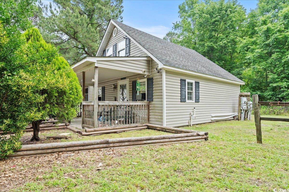 2776 Holly Road Marion, SC 29571 - Photo 4 of 29 View of side of home with roof with shingles, a po