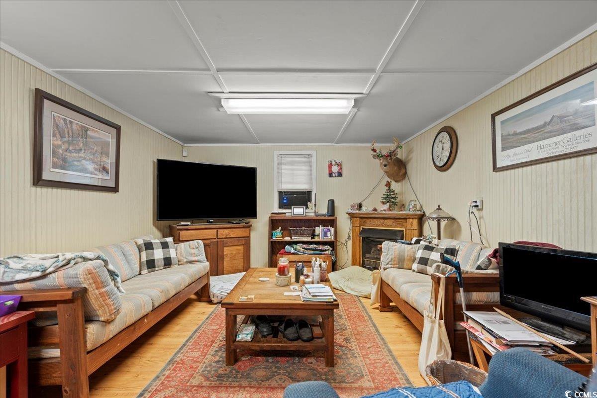 2776 Holly Road Marion, SC 29571 - Photo 10 of 29 Living room with light wood-style floors, crown mo