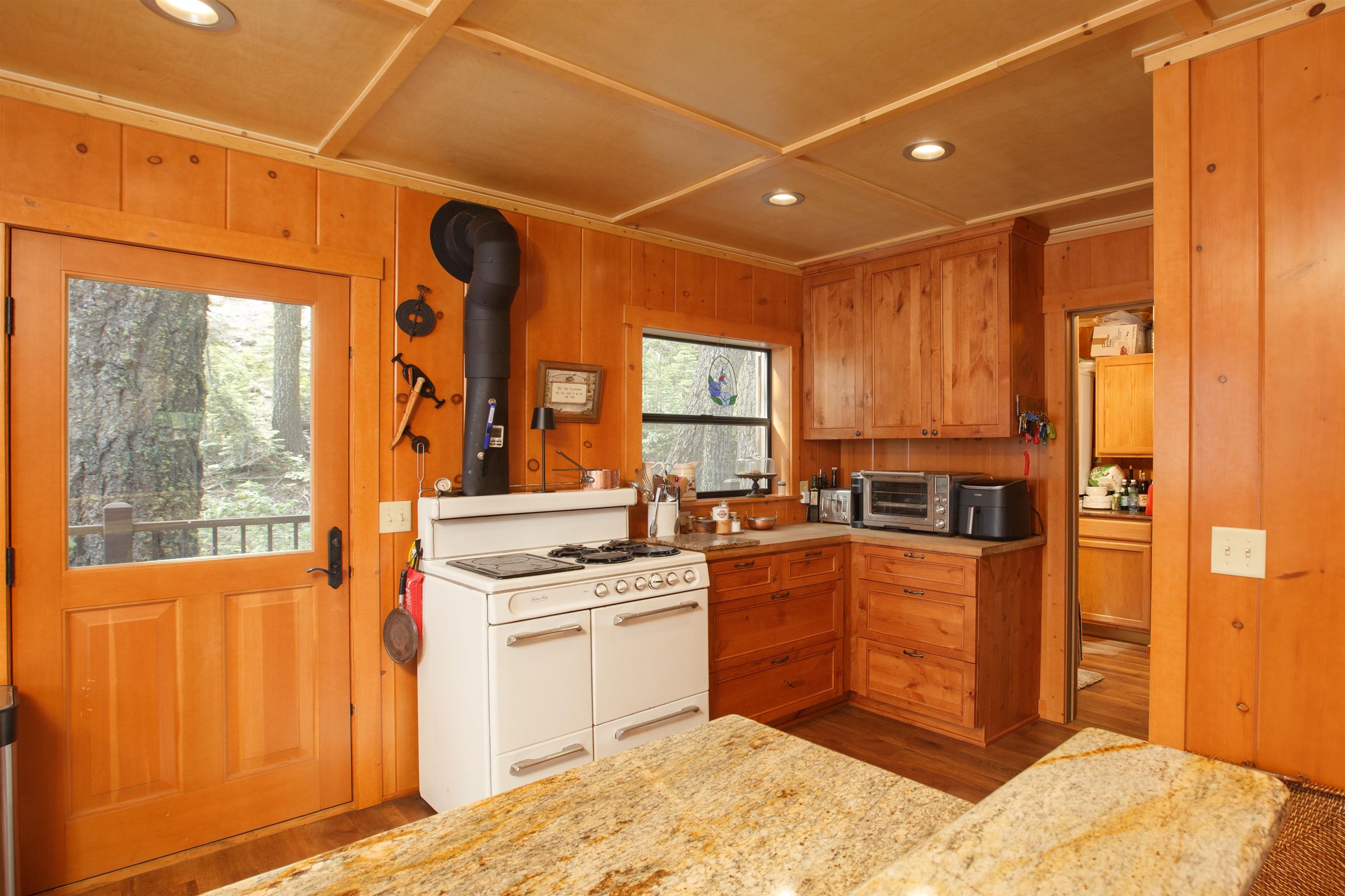 278 Mile High Road Quincy, CA 95971 - Photo 6 of 38 a kitchen with stainless steel appliances granite countertop a stove a sink and a refrigerator