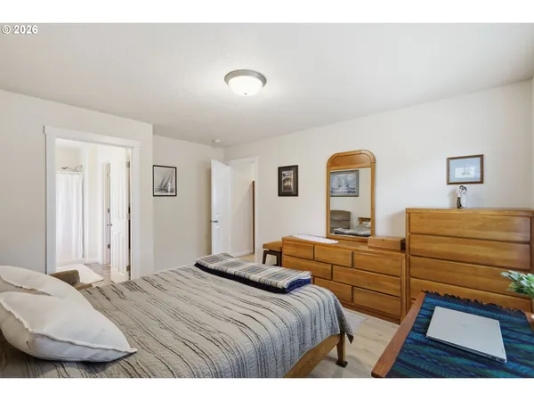 a bedroom with a bed and a dresser