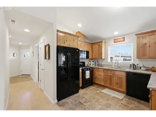 a kitchen with refrigerator and cabinets