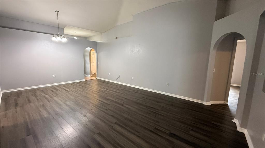 2210 Nicollett Way Leesburg, FL 34748 - Photo 11 of 31 an empty room with wooden floor and windows