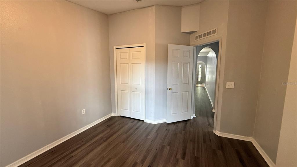 2210 Nicollett Way Leesburg, FL 34748 - Photo 13 of 31 a view of a room with wooden floor