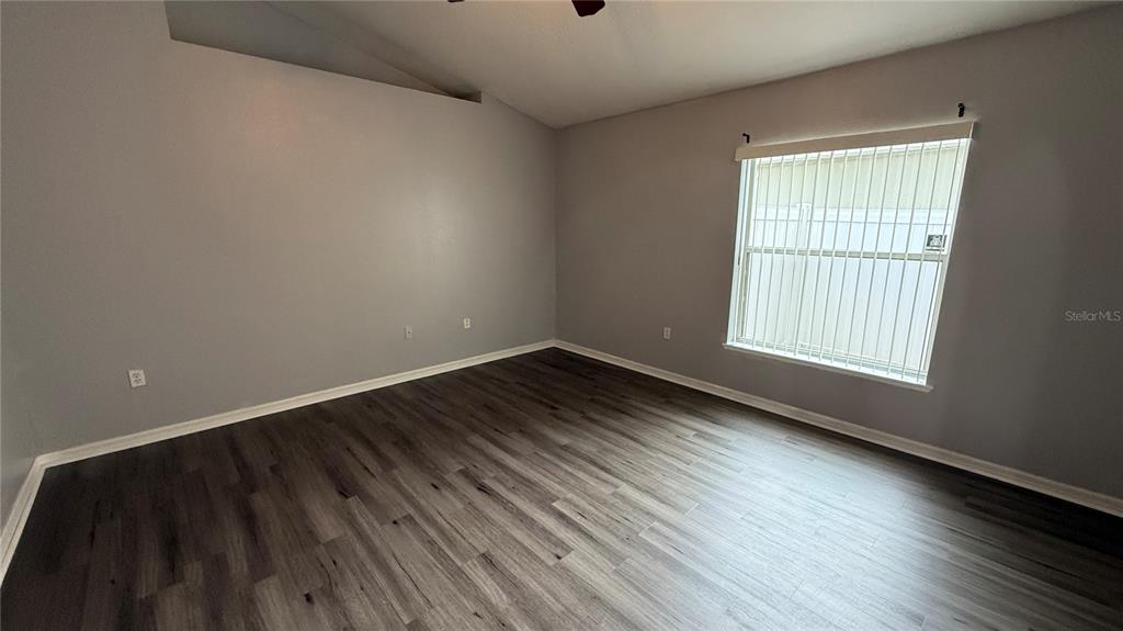 2210 Nicollett Way Leesburg, FL 34748 - Photo 14 of 31 wooden floor in an empty room with a window