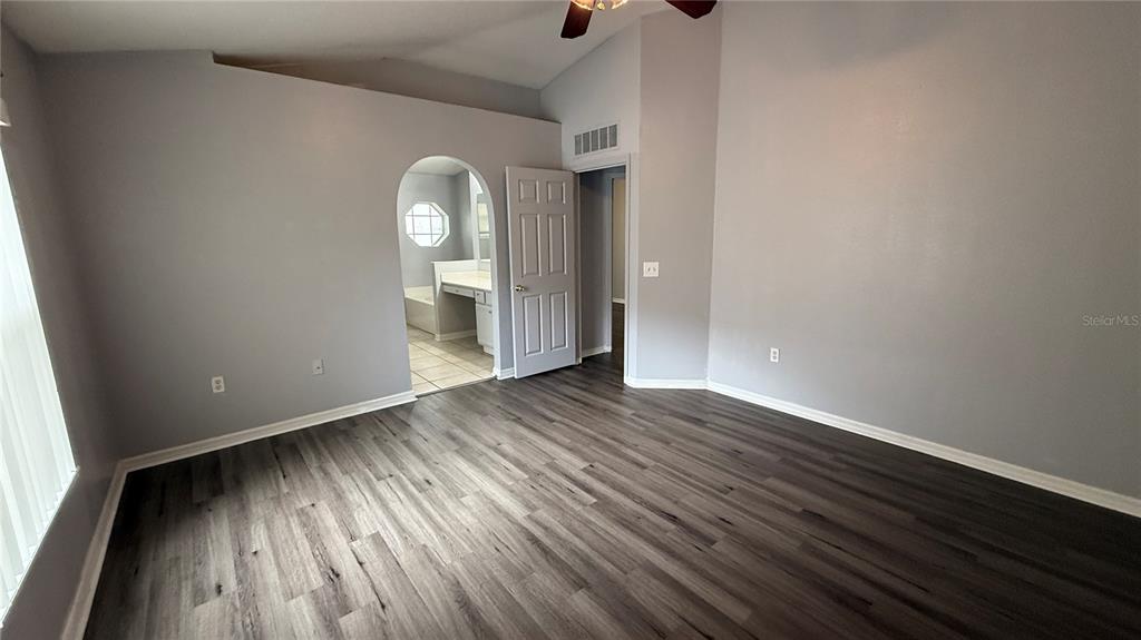 2210 Nicollett Way Leesburg, FL 34748 - Photo 16 of 31 a view of empty room with wooden floor and fan